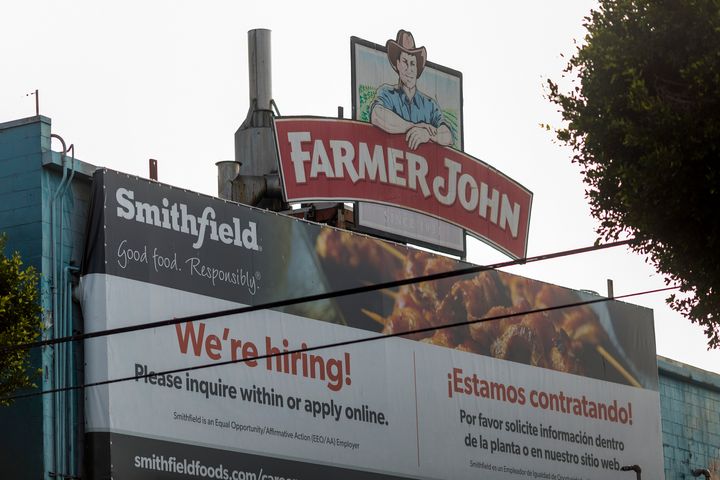 A sign on the Farmer John slaughterhouse in Vernon advertises job openings in May after more than 150 workers tested positive for COVID-19. California issued more than $100,000 against the plant and a temp firm. (Photo by David McNew/Getty Images)