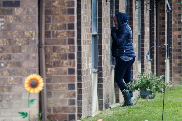 A woman visits her father at the Orchard Villa Retirement Centre on Mother's Day, May 10, 2020 in Pickering, Ont. 