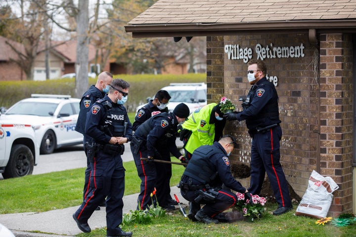 Durham Regional Police plant flowers at the front of Orchard Villa Retirement Centre on Mother's Day, May 10, 2020 in Pickering, Ont. 