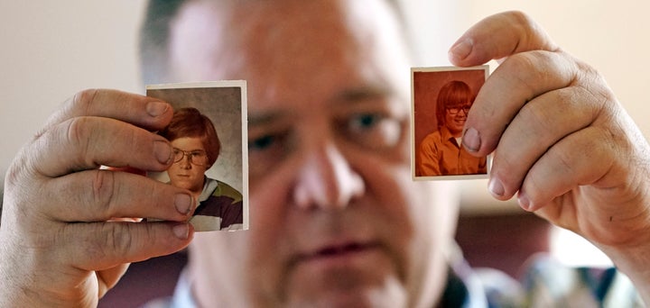 James Kretschmer holds photographs of himself at age 11 and 12 during an interview in Houston. He says he was molested by a Scout leader over several months in the mid-1970s in the Spokane, Washington, area. (AP Photo/David J. Phillip)