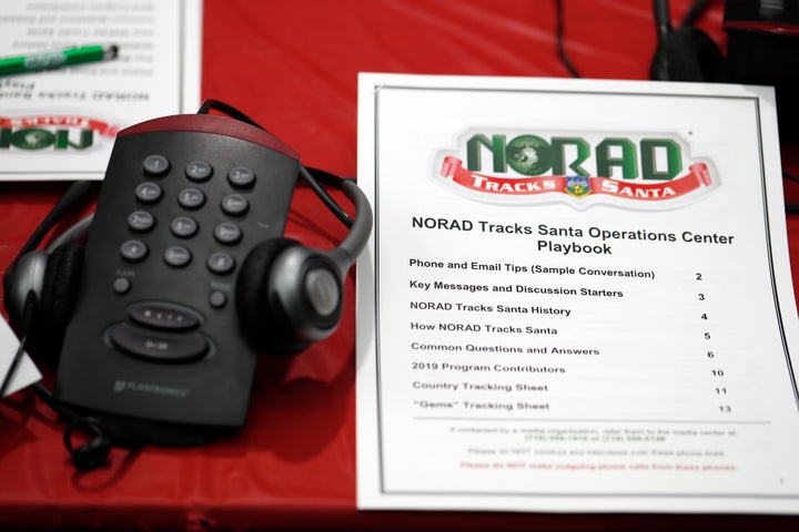 In this 2019 file photo, a playbook sits next to a telephone set up in the NORAD Tracks Santa center at Peterson Air Force Base in Colorado Springs, Colorado. 