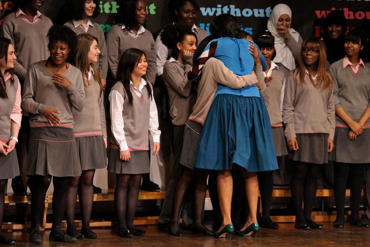 Michelle Obama hugs pupils during the visit to Elizabeth Garrett Anderson Language School in London, Thursday April 2, 2009. 