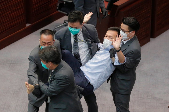 Pan-democratic legislator Raymond Chan Chi-chuen is taken away by security guards during a Legislative Council's House Committee meeting, in Hong Kong, on May 8, 2020. 