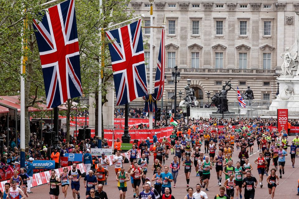 Crowds of athletes take the finishing straight in front of the Buckingham Palace during the 2019 Virgin Money London Marathon. 