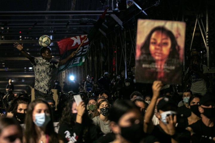 Demonstrators sit on New York's Brooklyn Bridge during one of the many marches in various cities that have spotlighted the police killing of Breonna Taylor in Louisville, Kentucky.