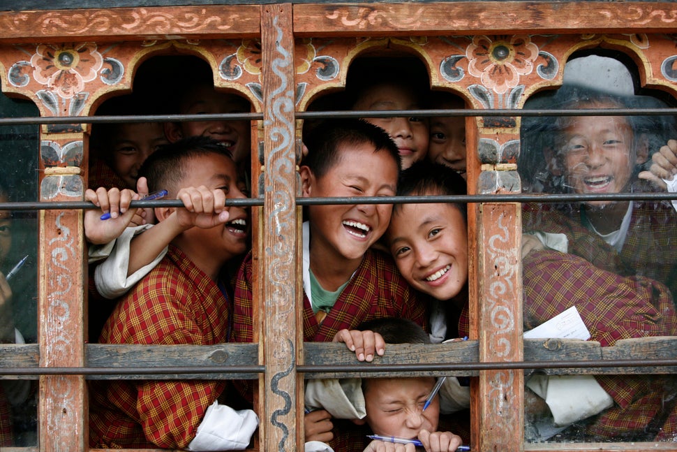 Schoolchildren react to the camera through the window of their classroom in a school in Thimphu, Bhutan, in 2010. Credit: Reuters