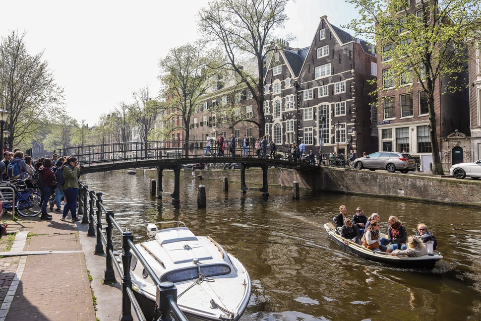 The city of Amsterdam, in the Netherlands, is trying to create an economy that can meet people’s needs without causing irreparable damage to the climate and nature. Credit: Nicolas Economou/NurPhoto via Getty Images