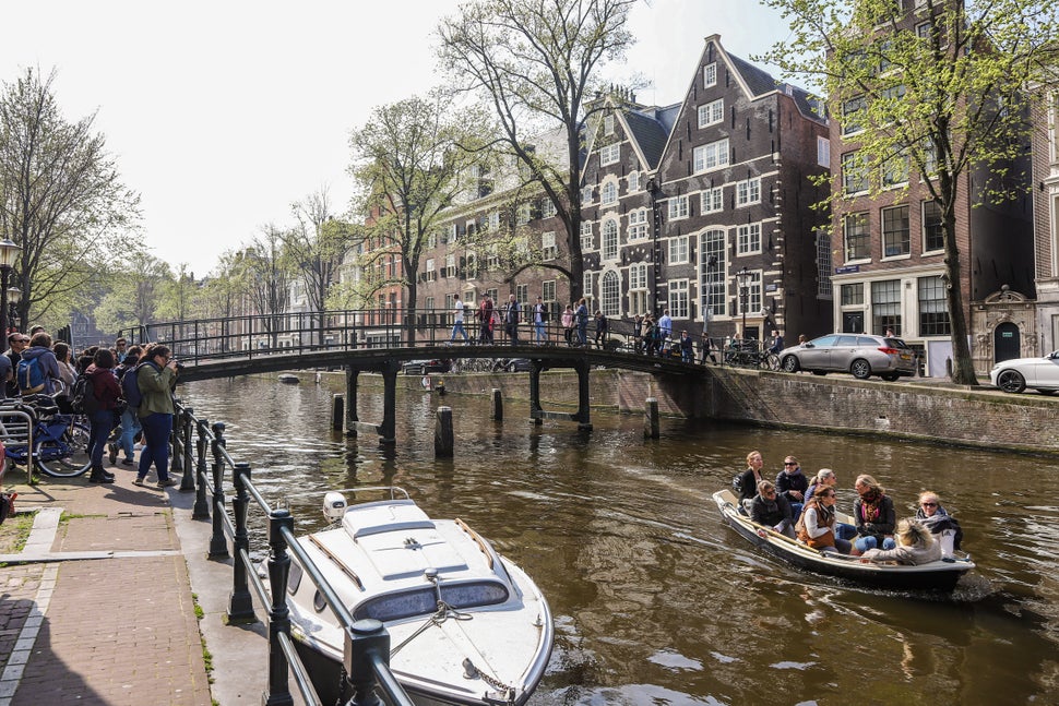 The city of Amsterdam, in the Netherlands, is trying to create an economy that can meet people’s needs without causing irreparable damage to the climate and nature. Credit: Nicolas Economou/NurPhoto via Getty Images