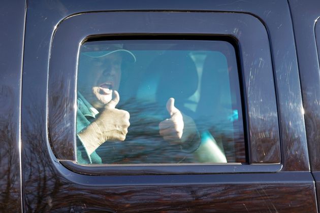 President Donald Trump acknowledges supporters Sunday as he departs the Trump National Golf Club in Sterling Virginia, after playing golf.