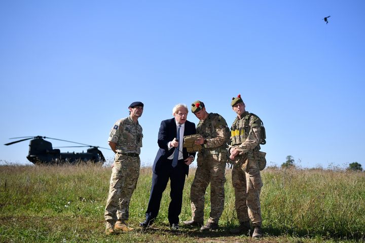 Boris Johnson flies a Black Hornet nano drone during a meeting with military personnel on Salisbury plain training area.