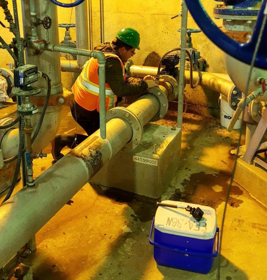 Researcher collecting "primary clarified sludge" from a wastewater treatment facility in Gatineau, Que. for COVID-19 testing.