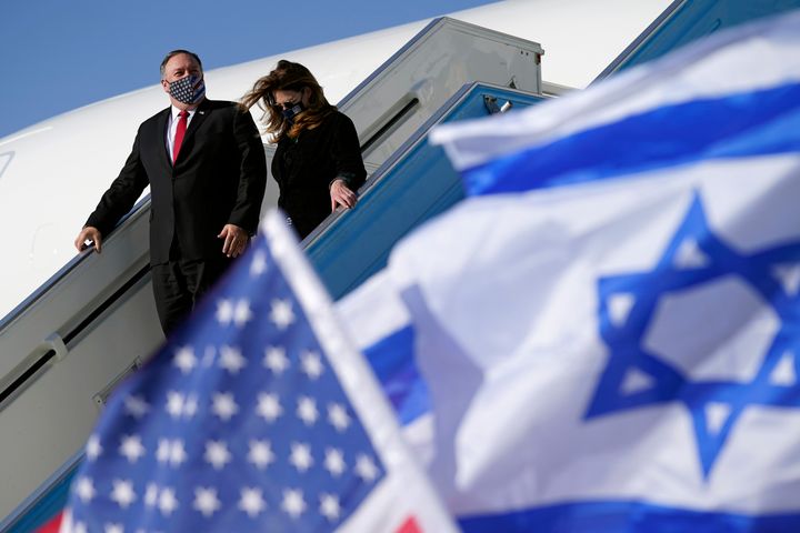 The secretary of state and his wife Susan are seen walking past American and Israeli flags as they step off a plane at Ben Gurion Airport in Tel Aviv on Wednesday.