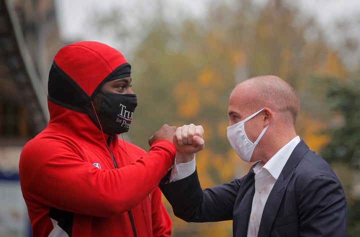 Rep. Max Rose (D-N.Y.), shown here greeting a supporter of President Donald Trump while on the campaign trail last month, repeatedly touted his opposition to police funding cuts. He lost anyway.