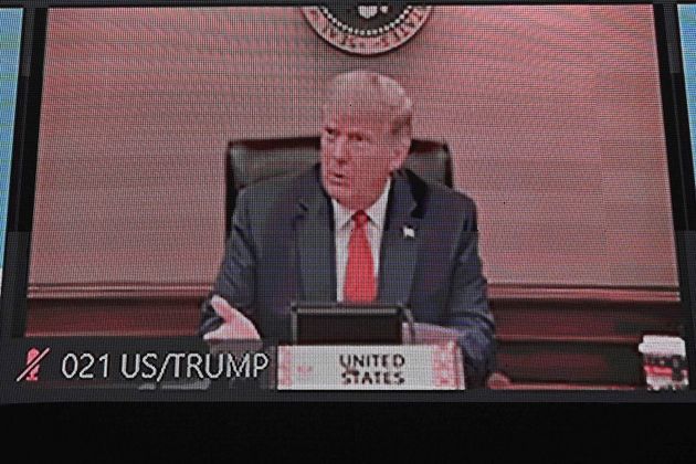 The President of the United States, Donald Trump, appears on a monitor screen while participating in the Asia-Pacific online ...