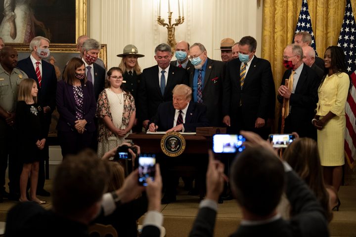 President Donald Trump signs the the Great American Outdoors Act at the White House on Aug. 4. The public lands law aims to fix crumbling national park infrastructure and permanently fund The Land and Water Conservation Fund. 