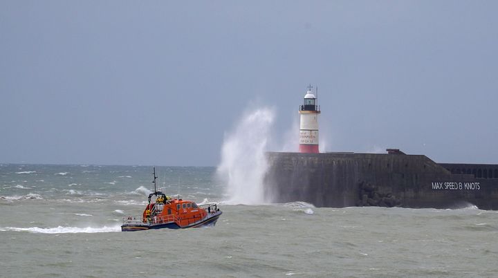A RNLI lifeboat continues the search for missing two fishermen who went missing near Seaford, Sussex, after their fishing boat sank. 