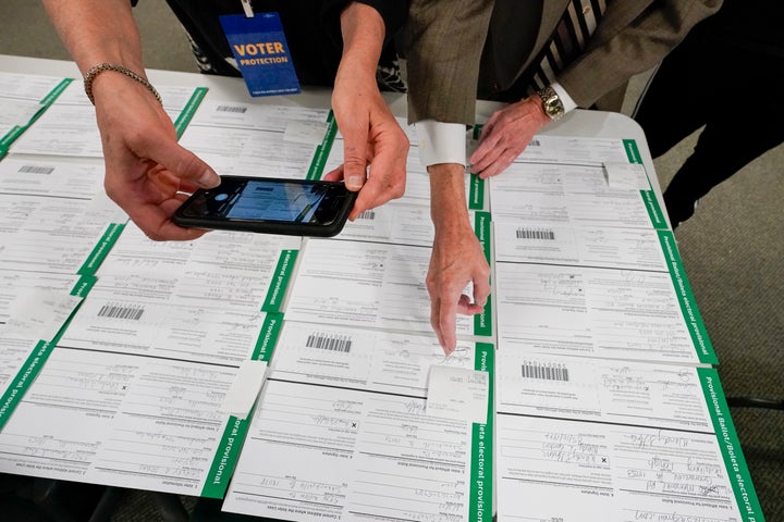 A canvas observer photographs Lehigh County provisional ballots, Friday, Nov. 6, 2020, in Allentown, Pa. (AP Photo/Mary Altaffer)