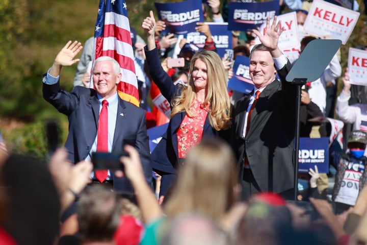 Vice President Mike Pence (from left) and Sens. Kelly Loeffler and David Perdue wave to supporters at a Defend the Majority R