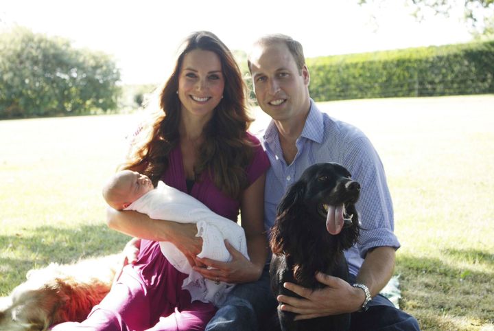 Prince William and Kate Middleton with newborn Prince George and their dog Lupo at the Middleton family home in August 2013.