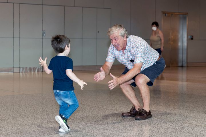Sydney based Grandad Alan Kinkade reunites with his grandson Tom, who lives in Melbourne, after six months of separation at Sydney domestic airport at Sydney Airport on November 23, 2020 in Sydney, Australia. 