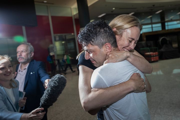 Genivieve Wild and Adam Deguara reunite after five months apart at Sydney Airport on November 23, 2020 in Sydney, Australia. 