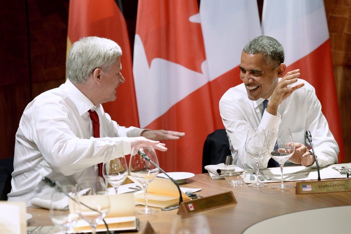 Stephen Harper jokes around as he talks with Barack Obama during dinner at the G7 meeting at Schloss Elmau near Garmisch, Germany on June 7, 2015.