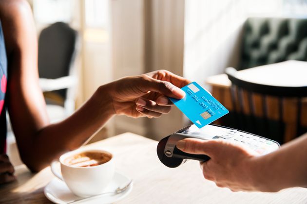 Woman using contactless payment, close up