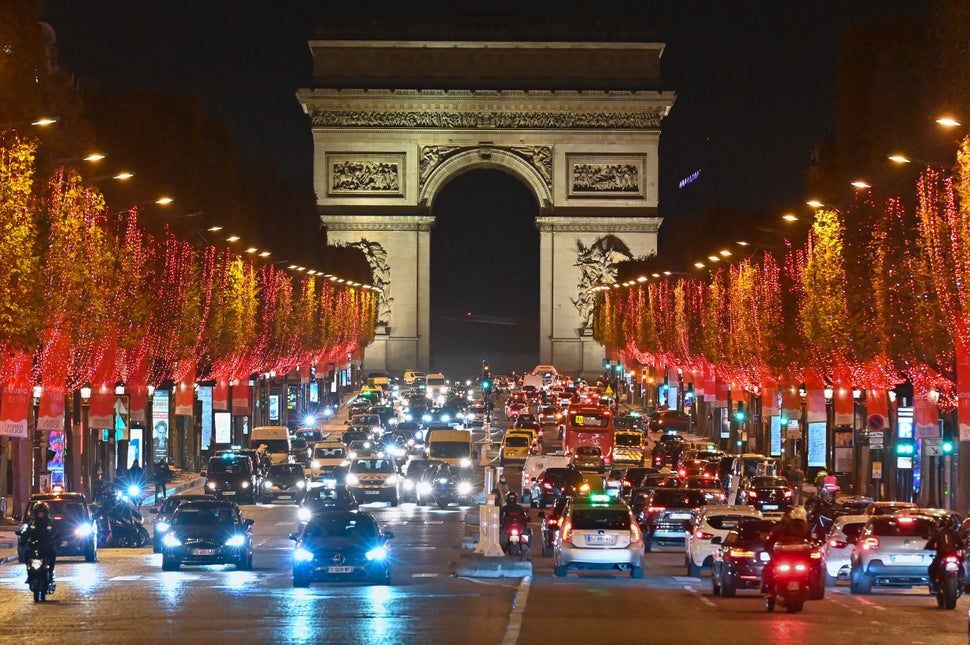 Christmas lights decorate the trees along the Champs-Elysees in Paris on Monday. Many European countries will this week unvei