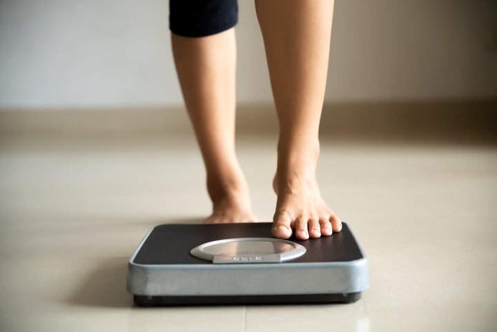 A woman steps onto a scale in this undated stock photo. Approximately one-third of Canadians surveyed in a new poll said they're exercising less during the coronavirus pandemic.