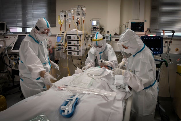 Nurses attend to a patient suffering form the novel coronavirus, Covid-19, in the Intensive Care Unit (ICU) at the Voula (Asklepeion) hospital located in an Athens' southern suburb on November 20, 2020. - The Greek ministry of health has announced the requisition of private hospitals in Thessaloniki on November 19, 2020 as the number of Covid-19 cases in the city is the highest in Greece, facing a second wave of the covid-19 pandemic caused by the novel coronavirus. (Photo by LOUISA GOULIAMAKI / AFP) (Photo by LOUISA GOULIAMAKI/AFP via Getty Images)