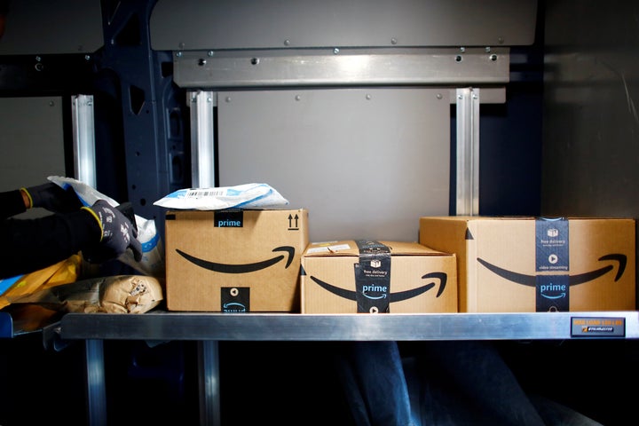 An Amazon worker delivers packages amid the coronavirus pandemic in Denver, Colo. on April 22, 2020.