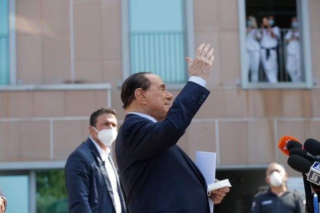 Former Italian premier Silvio Berlusconi greets as he leaves San Raffaele hospital in Milan, Italy, ...