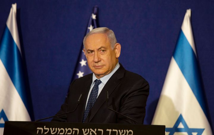 Israeli Prime Minister Benjamin Netanyahu listens during a news conference in Jerusalem, Thursday, Nov. 19, 2020. Israel’s defense minister on Sunday, Nov. 22, 2020 appointed a committee to investigate the government's controversial purchase of German submarines several years ago — a step that further strained his already poor relationship with Netanyahu. (AP Photo/Maya Alleruzzo, Pool)