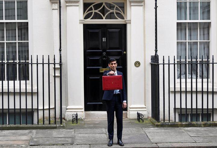 Chancellor of the Exchequer Rishi Sunak poses with a red briefcase outside his office in Downing Street in London, in March 