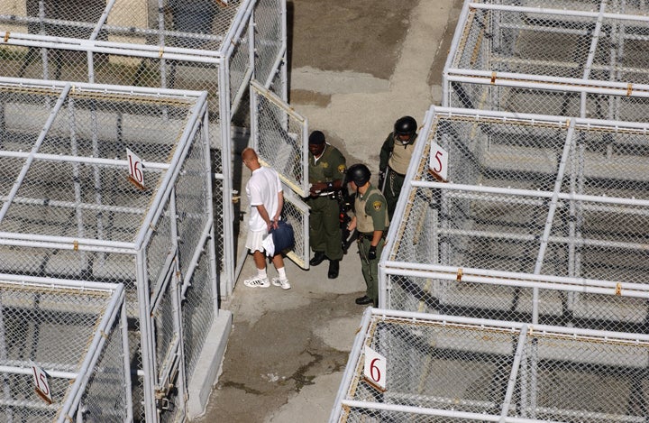 A guard at San Quentin prison is seen checking doors of cells housing death row inmates. At least 158 claims were filed in Ca
