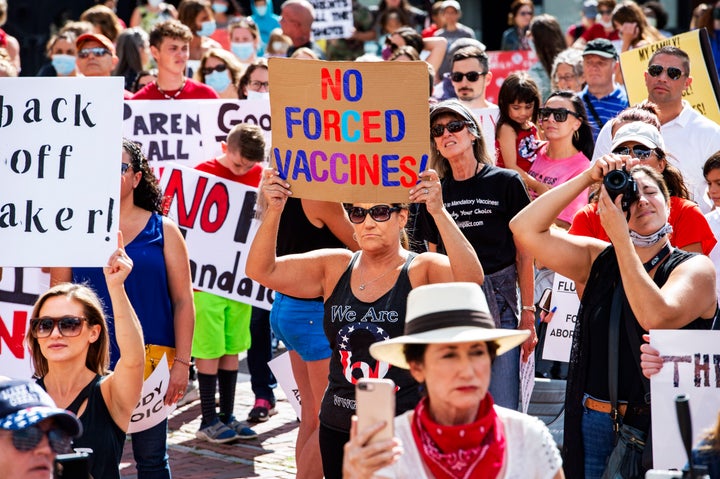 A woman wearing a QAnon shirt attends an Aug. 30 anti-vaccination protest at the Massachusetts State House in Boston.