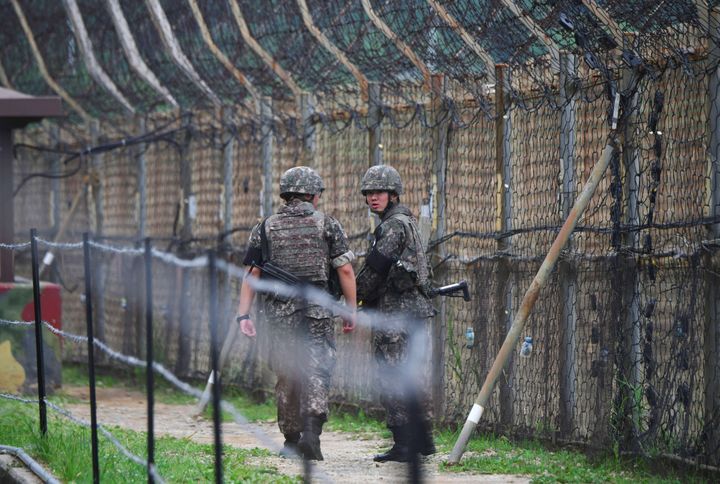 South Korean soldiers patrol a fence in the Demilitarized Zone (DMZ) dividing the two Koreas in Goseong on June 14, 2019.
