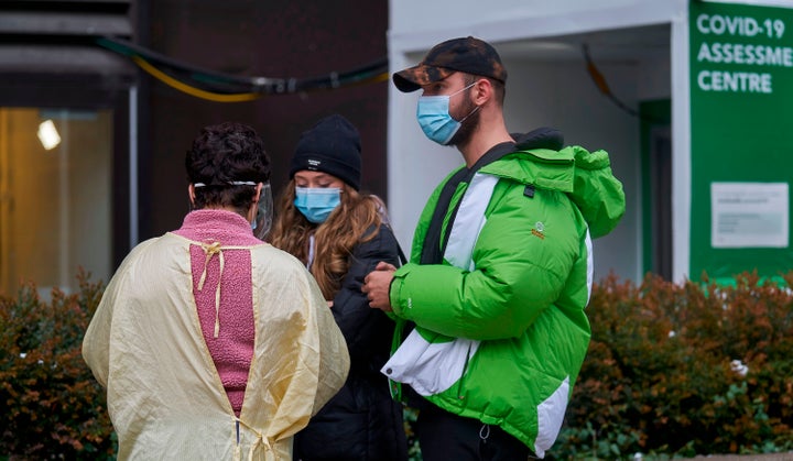 A nurse talks with people in line at a COVID-19 testing centre at Mount Sinai Hospital in Toronto, Ontario on Nov. 23, 2020.