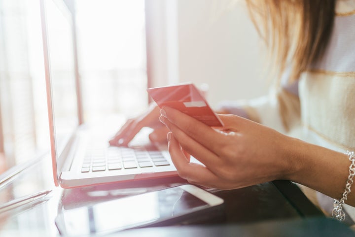 Close-up of woman buying from home on the laptop