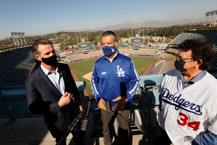 California Secretary of State Alex Padilla (center) celebrates the L.A. Dodgers' World Series win with Newsom (left). Padilla is widely viewed as a front-runner to replace Sen. Harris.