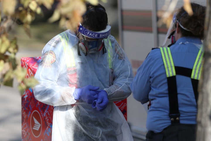 Members of the Winnipeg Fire Paramedic Service wear personal protective gear as they depart Maples Personal Care Home, in Winnipeg, Man., on Nov. 2, 2020.
