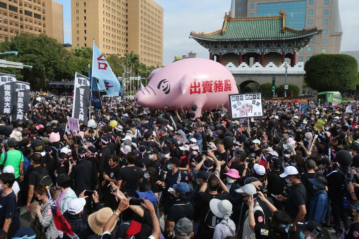 Thousands of people marched in streets on Sunday demanding the reversal of a decision to allow U.S. pork imports into Taiwan, alleging food safety issues.