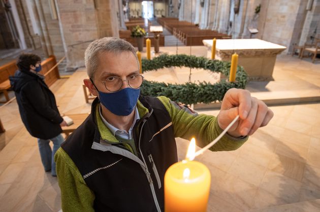 Cathedral sexton Ansgar Stuckenberg lights a candle on an Advent wreath in the Catholic St Peter's Cathedral, Lower Saxony, Osnabrück