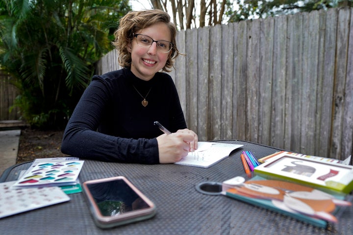 Kara McKlemurry poses for a photo while writing Thanksgiving notes to family and friends at her home Thursday, Nov. 19, 2020,