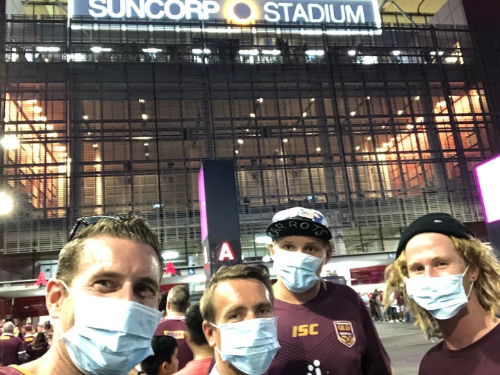 The writer and his mates don masks at the entrance of Suncorp Stadium in Brisbane.