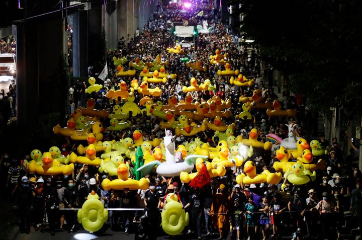 Protesters carry inflatable yellow ducks, which have become good-humored symbols of resistance during anti-government rallies, while marching towards the base of the 11th Infantry Regiment on Sunday in Bangkok, Thailand. (AP Photo/Sakchai Lalit)