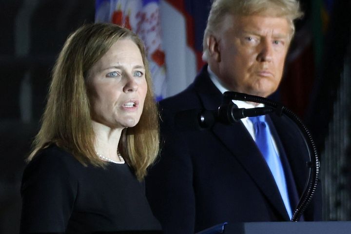 President Donald Trump looks on as Judge Amy Coney Barrett delivers remarks after she was sworn in as an associate justice of the Supreme Court on the South Lawn of the White House in Washington, October 26, 2020. (REUTERS/Jonathan Ernst)