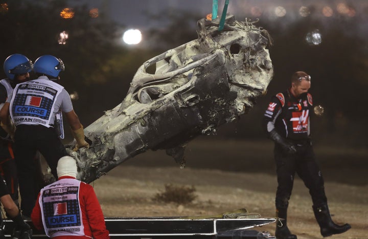 Track marshals clear the debris following the crash of Romain Grosjean of France and Haas F1 during the F1 Grand Prix of Bahrain.