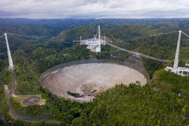 This aerial view shows a hole in the dish panels of the Arecibo Observatory in Arecibo, Puerto Rico, on November 19, 2020. (Photo by RICARDO ARDUENGO/AFP via Getty Images)
