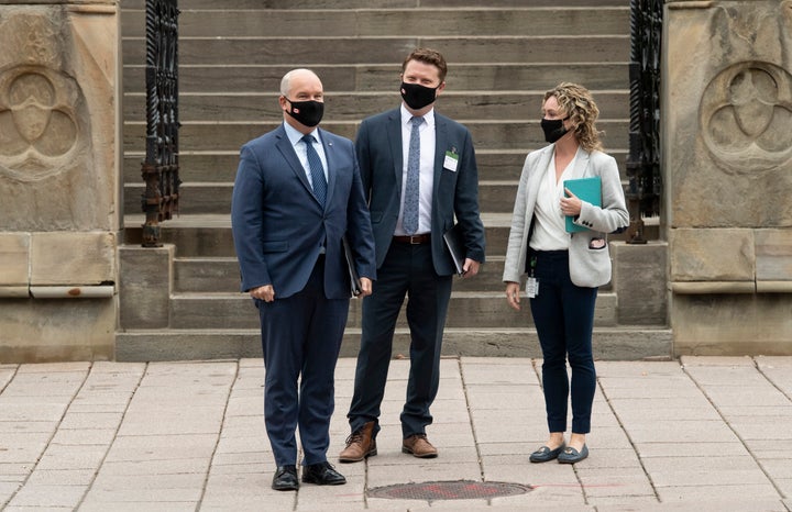 Conservative Leader Erin O'Toole, chief of staff Tausha Michaud and campaign manager Fred DeLorey wait to cross a road as they walk to national caucus, Sept. 9, 2020 in Ottawa.